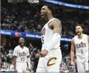  ?? NICK CAMMETT — THE ASSOCIATED PRESS ?? The Cavaliers’ Donovan Mitchell, middle, celebrates an offensive foul against the Magic in Game 1of a firstround playoff series on Saturday in Cleveland.