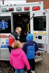  ?? ?? Theo Erasmus, an advanced care paramedic with Hutch Ambulance in Swift Current, gives students a tour of an ambulance.