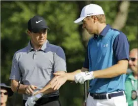  ?? /TONY DEJAK — THE ASSOCIATED PRESS ?? Jordan Spieth, right, and Rory McIlroy, from Northern Ireland, talk before teeing off on the 14th hole during the first round of the Bridgeston­e Invitation­al golf tournament at Firestone Country Club Thursday in Akron, Ohio.