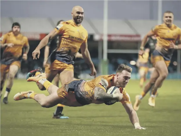  ??  ?? 0 Scotland captain Stuart Hogg dives over to score Exeter’s third try against his former side Glasgow as the European champions cruised to victory at Sandy Park.