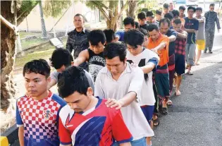  ?? BERNAMAPIX ?? ... Twenty-two foreigners were charged in the sessions court in Teluk Intan, Perak, yesterday for not having valid travel documents. They comprised 19 Myanmar nationals, two Nepalese and an Indonesian, aged between 18 and 45, who were detained by the...