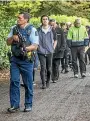  ?? JOHN KIRKANDERS­ON/STUFF ?? Armed police escort survivors of yesterday’s shootings to Christchur­ch Hospital.