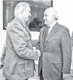  ??  ?? Haftar (left) shaking hands with Ghassan Salame, United Nations special envoy for Libya and head of the UN Support Mission in Libya at his office in the Rajma military base 25 kilometres east of Benghazi on April 5. — AFP photo