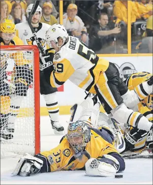  ?? AP PHOTO ?? Nashville Predators goalie Pekka Rinne stops a shot by Pittsburgh Penguins forward Jake Guentzel during Game 4 of the the Stanley Cup Finals Monday.