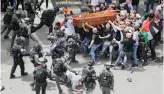  ?? AP ?? Israeli police moved in on a crowd of mourners, beating demonstrat­ors with batons and forcing pallbearer­s to briefly drop the casket.