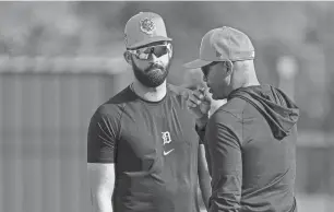  ?? JUNFU HAN/DETROIT FREE PRESS ?? Tigers outfielder Riley Greene talks to bench coach George Lombard during spring training at Tigertown in Lakeland, Fla. on Feb. 13.