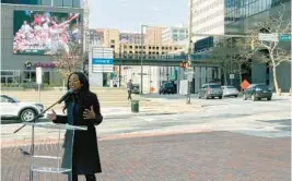  ?? LORRAINE MIRABELLA/BALTIMORE SUN ?? Shelonda Stokes, president of the Downtown Partnershi­p of Baltimore, unveils the first two digital billboards in the city’s downtown sign district.