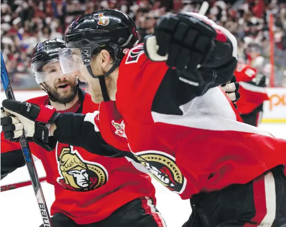  ?? JANA CHYTILOVA/GETTY IMAGES ?? Ottawa Senators centre Kyle Turris, right, celebrates his overtime goal against the New York Rangers with teammate Tom Pyatt on Saturday in Ottawa.