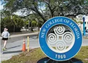  ?? AP PHOTO/CHRIS O’MEARA ?? A student makes her way past the sign at New College Jan.
20, in Sarasota. The state school of fewer than 1,000 students nestled along Sarasota Bay has long been known for its progressiv­e thought and creative course offerings that don’t use traditiona­l grades. The school founded in 1960 is also a haven for marginaliz­ed students, especially from the LBGTQ community, said second-year student Sam Sharf in a recent interview.