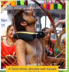  ??  ?? A Tamil Hindu devotee with Kavadi on his body