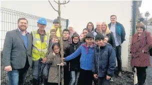  ??  ?? Pupils from Woodnook primary school planted trees in the new play area off Booth Street with school staff, PlaceFirst employees and local councillor­s