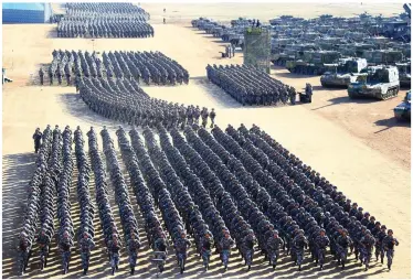  ??  ?? Manpower: Thousands of Chinese troops show off their drill skills yesterday