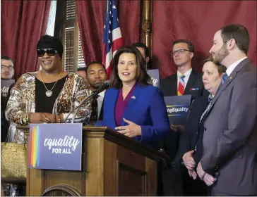  ?? ASSOCIATED PRESS FILE PHOTO ?? In 2019, Michigan Gov. Gretchen Whitmer, center, joins with lawmakers and others in the Capitol building in Lansing, calling for expanding the state’s civil rights law to prohibit discrimina­tion against LGBT people. LGBTQ protection­s will be added to state civil rights law either by the legislativ­e process or Michigan voter approval, two state legislator­s vowed Monday.