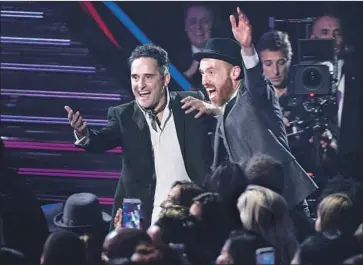  ?? Chris Pizzello Invision / AP ?? JORGE DREXLER, left, celebrates a winning night at the Latin Grammy Awards on Thursday in Las Vegas.