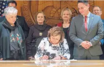  ?? EDDIE MOORE/JOURNAL ?? Gov. Susana Martinez, flanked by Sen. Gay Kernan, R-Hobbs, left, and Sen. Howie Morales, D-Silver City, right, signs a bill Thursday to allow New Mexico nurses licensed in other states to continue working here. Standing behind the governor are Senate...