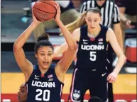  ?? Kathy Willens / Associated Press ?? UConn’s Olivia Nelson-Ododa (20) looks to pass with Paige Bueckers (5) looking on during a win at St. John’s last week.