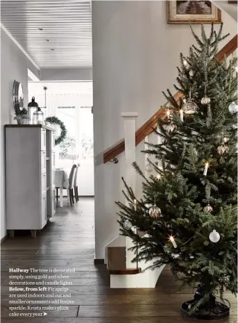  ??  ?? Hallway The tree is decorated simply, using gold and silver decoration­s and candle lights Below, from left Fir sprigs are used indoors and out and smaller ornaments add festive sparkle; Krista makes plum cake every year ➤