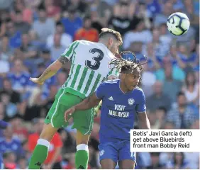  ??  ?? Betis’ Javi Garcia (left) get above Bluebirds front man Bobby Reid