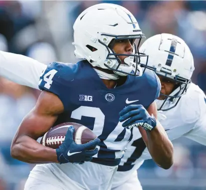  ?? SCOTT TAETSCH/GETTY PHOTOS ?? London Montgomery (24) carries the ball as Abdul Carter defends during the Penn State Spring Football Game at Beaver Stadium on Saturday in State College, Pennsylvan­ia.