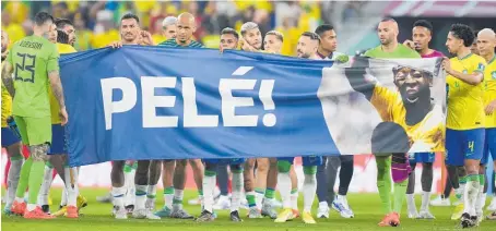  ?? Photos / AP ?? Brazil players hold a banner with a message of support for ailing former star, Pele.