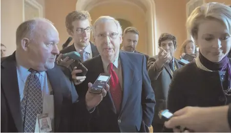  ?? AP PHOTO ?? ALL EARS: Reporters gather around Senate Majority Leader Mitch McConnell before yesterday’s marathon session to approve a comprehens­ive tax reform package.