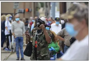  ?? (Arkansas Democrat-Gazette/Staton Breidentha­l) ?? Kanisha Hatton listens to music and dances Monday while waiting in line to vote at the Pulaski County Regional Building in downtown Little Rock.