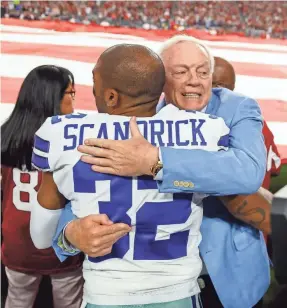  ?? MARK J. REBILAS/USA TODAY SPORTS ?? Jerry Jones hugs cornerback Orlando Scandrick. Jones said all Dallas Cowboys are required to stand for the national anthem.