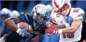  ??  ?? Memphis receiver Anthony Miller, left, stiff arms SMU defender Jordan Wyatt while scrambling for a first down during first quarter action Nov. 18 in Memphis. MARK WEBER / THE COMMERCIAL APPEAL