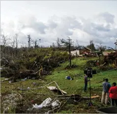  ?? VASHA HUNT/ AP ?? Investigat­ors survey heavy damage in Clanton, Alabama, on Thursday, a day after severe storms swept across the Southeast. The Weather Service received 116 reports of severe weather from Texas to Georgia.