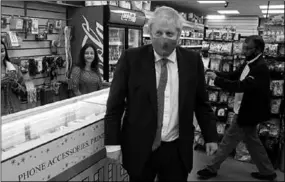  ??  ?? The PM wore a mask for the first time in public on Friday, in his Uxbridge constituen­cy, west of London. ( Photo: CNN )