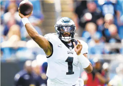  ?? JACOB KUPFERMAN/AP PHOTOS ?? Eagles quarterbac­k Jalen Hurts passes against the Panthers on Sunday in Charlotte, North Carolina. Hurts rushed for the gamewinnin­g touchdown late in the fourth quarter.