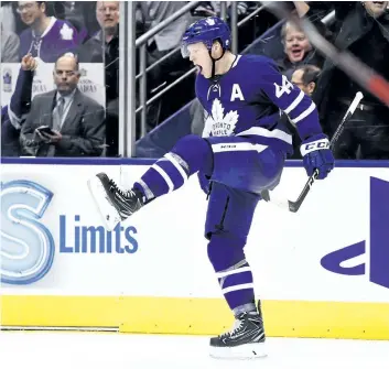  ?? NATHAN DENETTE/THE CANADIAN PRESS ?? Toronto Maple Leafs’ defenceman Morgan Rielly celebrates his goal against the Calgary Flames during second period NHL hockey action in Toronto on Wednesday, Dec.6.
