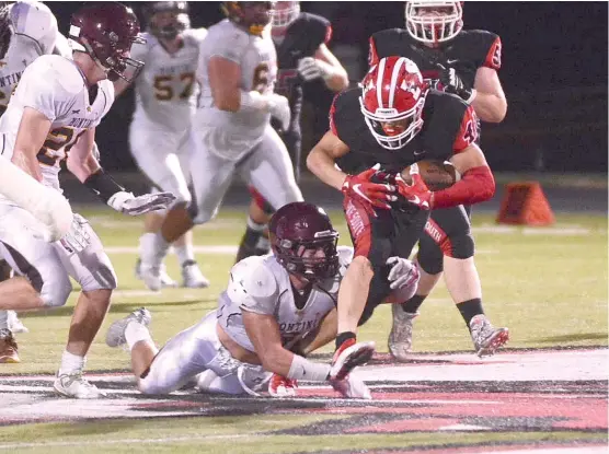  ?? | WORSOM ROBINSON/ FOR THE SUN- TIMES ?? Maine South running back Fotis Kokosiouli­s fights for a first down in the first half Friday against Montini. He ran for 211 yards and two touchdowns.