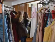  ??  ?? Guests browse the free prom dresses available at the First Presbyteri­an Church of Oneida’s Prom Dress Giveaway.