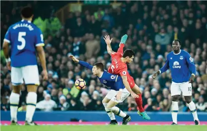  ??  ?? LIVERPOOL: Liverpool’s Croatian defender Dejan Lovren (2R) vies in the air with Everton’s English midfielder Ross Barkley during the English Premier League football match between Everton and Liverpool at Goodison Park in Liverpool, north west England...