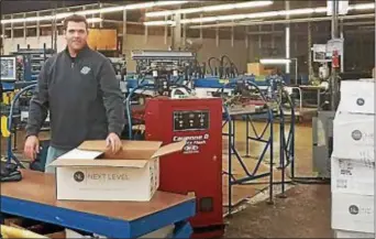  ?? SUBMITTED PHOTO ?? Rob Johnson of Ampro in the Primos section of Upper Darby boxes up some of the 30,000-plus Eagles Super Bowl championsh­ip shirts that rolled off the firm’s presses Sunday night into Monday morning, minutes after the Eagles won their first-ever Super...