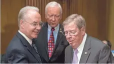  ?? ANDREW HARNIK, AP ?? Rep. Tom Price, R- Ga., left, the nominee for Health and Human Services secretary, greets Sen. Orrin Hatch, R-Utah, center, and Sen. Johnny Isakson, R- Ga., on Capitol Hill on Tuesday.