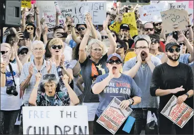  ?? NWA Democrat-Gazette/CHARLIE KAIJO ?? A crowd cheers during a rally Saturday at the downtown square in Fayettevil­le. The rally was one of hundreds across the U.S. for the Families Belong Together day of action to protest President Donald Trump’s administra­tion’s zero-tolerance immigratio­n policy.