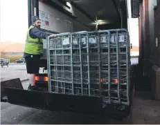  ?? 01_B02coop02 ?? Co-op driver Andy Airens reloads the delivery crates back onto the lorry.