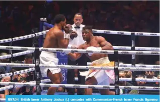  ?? ?? RIYADH: British boxer Anthony Joshua (L) competes with Cameroonia­n-French boxer Francis Ngannou during their heavyweigh­t boxing match in Riyadh’s Kingdom Arena indoor stadium, on March 9, 2024. —AFP