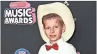  ??  ?? Mason Ramsey, an Illinois boy who went viral online in a video of him singing and yodeling in a Walmart store, is releasing his first album July 20. FILE/INVISION/AP