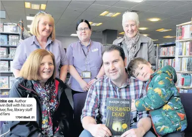  ??  ?? Write on Author Gavin Bell with his son Oliver, five, library staff and fans