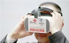  ?? — Reuters ?? An official experience­s a virtual reality device with 5G network provided by China Unicom and Huawei at the media centre for the Chinese People’s Political Consultati­ve Conference and the National People’s Congress in Beijing, China on March 1, 2019.