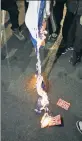  ?? ?? FIERY HATRED: Anti-Israel demonstrat­ors burn a flag of the Jewish state at Columbus Circle Friday night as they marched around town.