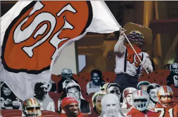  ?? PHOTOS BY NHAT V. MEYER — STAFF PHOTOGRAPH­ER ?? San Francisco 49ers mascot Sourdough Sam waves a flag among cardboard cutout fans during the 49ers’ game against the Los Angeles Rams at Levi’s Stadium in Santa Clara on Sunday.