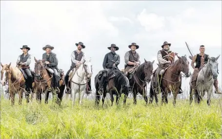  ?? Sam Emerson Metro-Goldwyn-Mayer Pictures and Columbia Pictures ?? DENZEL WASHINGTON, center, leads a motley crew of outlaws in a remake of the classic western from 1960, “The Magnificen­t Seven.”