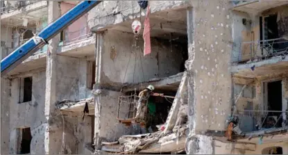  ?? MAXIM PENKO / AP ?? A Ukrainian firefighte­r carries out work at a damaged building in the town of Serhiivka, located about 50 kilometers southwest of Odessa, on July 2. The real trigger of the Russia-Ukraine conflict is said to be the constant NATO expansion.