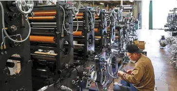  ?? — Reuters ?? Weathering the storm: A worker checks machinery at a factory in Higashiosa­ka. The region has a history as a manufactur­ing hub dating back hundreds of years but most firms are struggling due to the weak yen and rising costs.