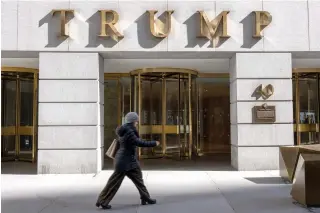  ?? ?? People walk by 40 Wall Street, a Trump-owned building in downtown Manhattan on March 19, 2024 in New York City. (Photo by SPENCER PLATT / GETTY IMAGES NORTH AMERICA / Getty Images via AFP)