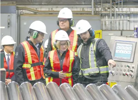 ?? JIM WELLS ?? Premier Rachel Notley speaks with company representa­tives during a tour of Tenaris, a manufactur­er and supplier of steel pipe products in Calgary on Friday. During the stop, the premier announced the appointmen­t of a task force to help get new...